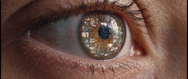 An eye with a wall of images reflected in its iris